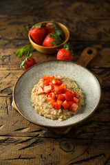 Healthy quinoa porridge with fresh strawberry