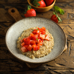 Healthy quinoa porridge with fresh strawberry