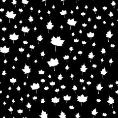 Seamless vector pattern with white maple leaves on a black background. Modern stylish botanicalt flat style illustration for fabric print, wrapping paper