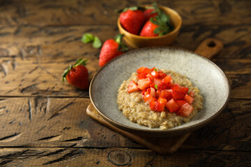 Healthy quinoa porridge with fresh strawberry