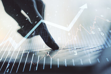 Abstract creative financial graph with upward arrow and hands typing on laptop on background,...