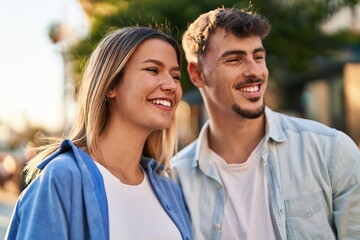 Obraz premium Young man and woman couple smiling confident standing together at street
