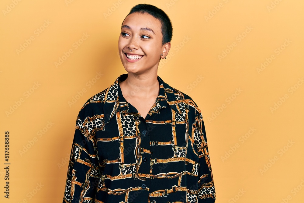 Canvas Prints Beautiful hispanic woman with short hair wearing elegant shirt looking away to side with smile on face, natural expression. laughing confident.