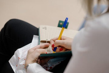 A woman's writing hand.A woman writes in a notebook close-up