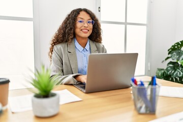 Young latin woman smiling confident working at office