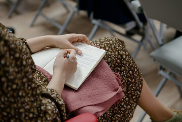 A woman's writing hand.A woman writes in a notebook close-up