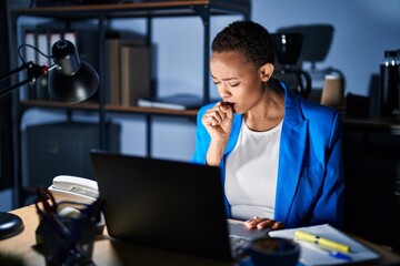Beautiful african american woman working at the office at night feeling unwell and coughing as symptom for cold or bronchitis. health care concept.