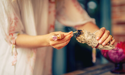 incense in a woman hand, ceremony space.