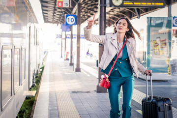 Beautiful girl running and chasing the leaving train in station. Waving hand and rushing to get on...