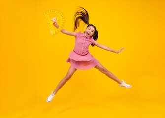 Amazed teenager. Measuring school equipment. Schoolgirl holding measure for geometry lesson, isolated on yellow background. Crazy jump, jumping kids. Student study math. Excited teen girl.