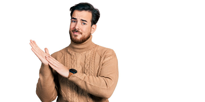 Young hispanic man wearing casual clothes clapping and applauding happy and joyful, smiling proud hands together