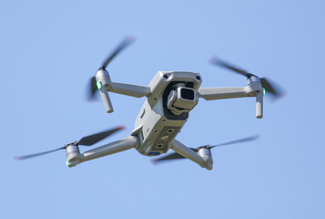 Drone in flight on blue sky.
