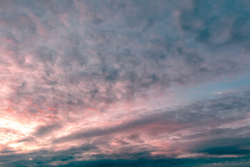 Naklejka na ściany i meble Clouds in the sky at sunset .
