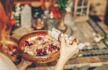 incense in a woman hand, ceremony space.