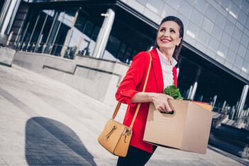 Photo of shiny good mood mature lady teacher wear red jacket holding stuff leaving work outside...