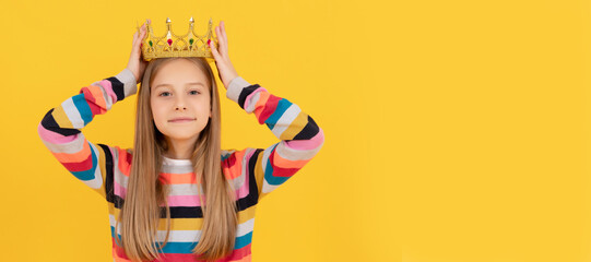 selfish teen child in queen crown on yellow background. Child queen princess in crown horizontal...
