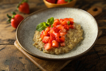 Healthy quinoa porridge with fresh strawberry