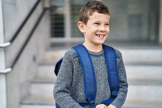 Blond child student smiling confident standing at school