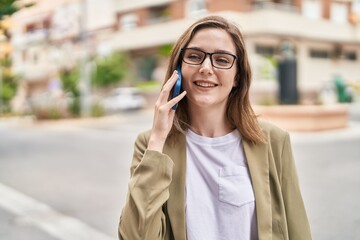 Young woman business worker talking on smartphone at street