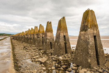 The exposed causeway and concrete spikes (used to prevent naval attacks in World War 2) across the...