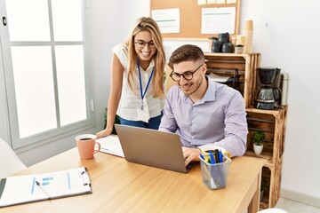 Two business workers smiling happy working at the office.