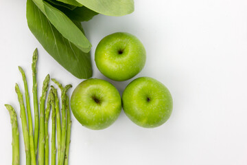 Fresh Vigetables and Green Asparagus and three apples isolated on white background