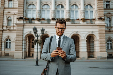 Close up shot of businessman's hand holding smart phone. Communication technology concept. Cinematic color grade.