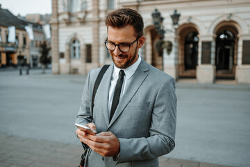 Close up shot of businessman's hand holding smart phone. Communication technology concept. Cinematic color grade.