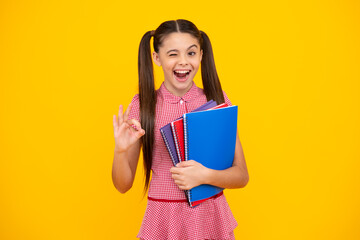 Teenager school girl study with books. Learning knowledge and kids education concept. Happy teenager, positive and smiling emotions of teen schoolgirl.