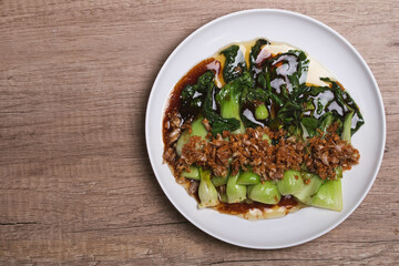 Baby Bok choy or chinese cabbage in oyster sauce with and fried garlic.