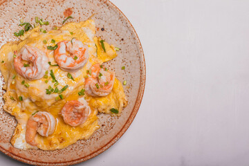 Creamy omelette with shrimps on rice served fish sauce, Thai style