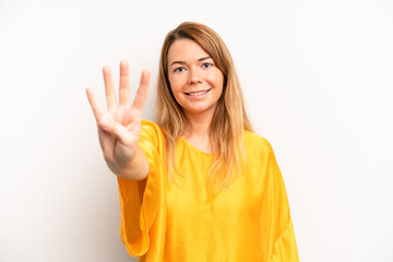 blonde pretty woman smiling and looking friendly, showing number four or fourth with hand forward,...
