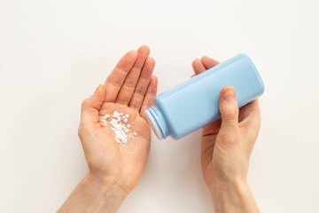 Applying white talcum powder on hand. Skin care cosmetic