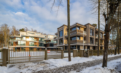 Modern exterior of new luxury residential building at winter.