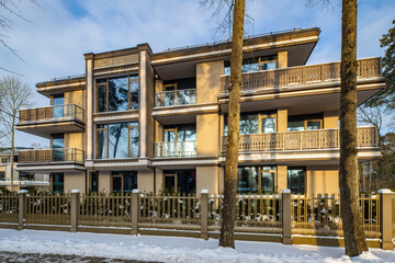 Modern exterior of new luxury residential building at winter.