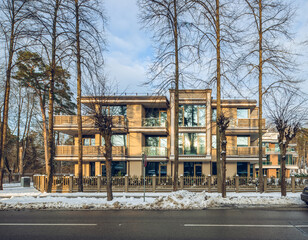 Modern exterior of new luxury residential building at winter.