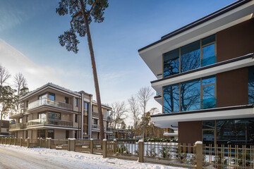 Modern exterior of new luxury residential building at winter.