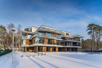 Modern exterior of new luxury residential building at winter.