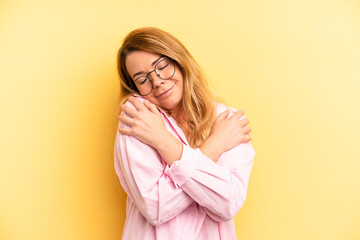 blonde pretty woman feeling in love, smiling, cuddling and hugging self, staying single, being...