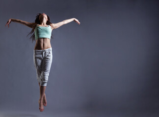 beauty girl dance on grey background