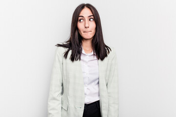 Young business caucasian woman isolated on white background confused, feels doubtful and unsure.