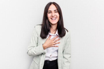 Young business caucasian woman isolated on white background laughs out loudly keeping hand on chest.