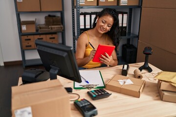 Young chinese woman ecommerce business worker using touchpad at office