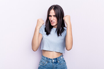 Young caucasian woman isolated on pink background upset screaming with tense hands.