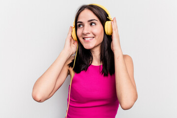 Young caucasian woman listening to music isolated on white background