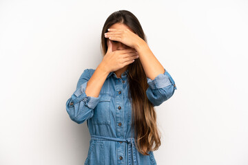 asian pretty woman covering face with both hands saying no to the camera! refusing pictures or...