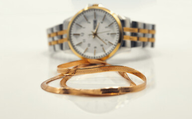 Elegant women's watch and gold chain with snakeskin weave