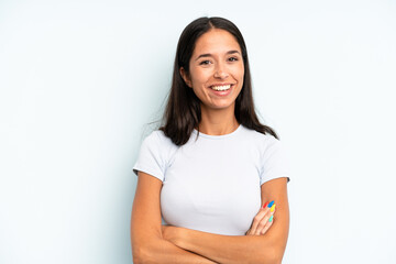 hispanic pretty woman looking like a happy, proud and satisfied achiever smiling with arms crossed
