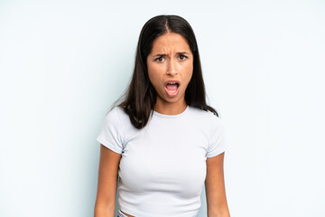 hispanic pretty woman looking shocked, angry, annoyed or disappointed, open mouthed and furious