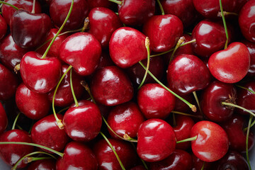 Top view of ripe fresh sweet cherry. Sweet cherry. Juicy red cherry background with copy space. Closeup view. Vegan and vegetarian concept. Fresh organic berry harvest.